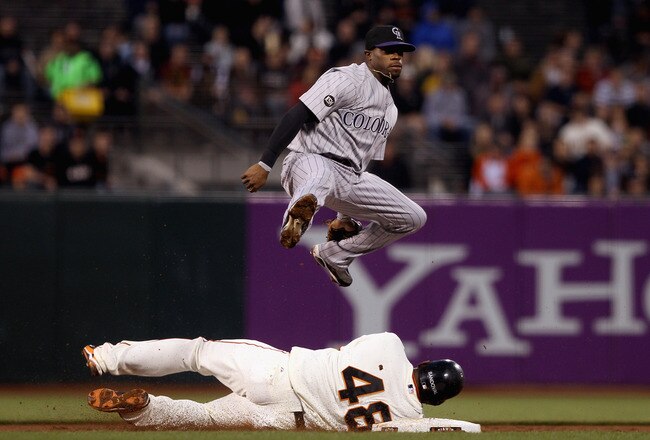 SAN FRANCISCO - AUGUST 31:  Eric Young Jr. #3 of the Colorado Rockies jumps over Pablo Sandoval #48 of the San Francisco Giants after he threw the ball to first base to turn a double play in the second inning at AT&T Park on August 31, 2010 in San Francisco, California.  (Photo by Ezra Shaw/Getty Images)