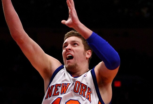 NEW YORK - FEBRUARY 17: David Lee #42 of the New York Knicks drives to the basket on Tim Duncan #21 of the San Antonio Spurs at Madison Square Garden February 17, 2009 in New York City. NOTE TO USER: User expressly acknowledges and agrees that, by downloading and/or using this Photograph, User is consenting to the terms and conditions of the Getty Images License Agreement.  (Photo by Chris McGrath/Getty Images)