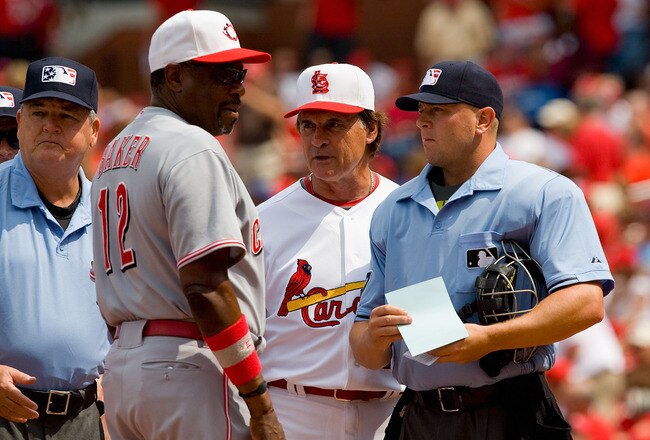 ST. LOUIS - MAY 31:  Tony LaRussa #10 of the St. Louis Cardinals, Dusty Baker #12 the Cincinnati Reds and umpires Jerry Crawford #2 and Scott Barry #87 meet before the game at Busch Stadium on May 31, 2010 in St. Louis, Missouri.  (Photo by Dilip Vishwanat/Getty Images)