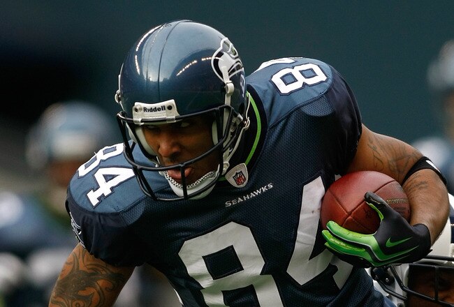 SEATTLE , WA - JANUARY 03:  T.J. Houshmandzadeh #84 of the Seattle Seahawks runs after making a catch against Rod Hood #37 of the Tennessee Titans at Qwest Field on January 3, 2010 in Seattle, Washington.  (Photo by Jonathan Ferrey/Getty Images)