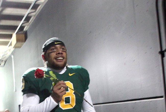 EUGENE, OR - DECEMBER 3:  Quarterback Jeremiah Masoli #8 of the Oregon Ducks celebrates their Civil War victory over Oregon State holding a rose at Autzen Stadium on December 3, 2009 in Eugene, Oregon. The Ducks defeated the Beavers 37-33. (Photo by Tom Hauck/Getty Images)