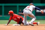 WASHINGTON - JULY 29:  Nyjer Morgan #1 of the Washington Nationals steals second base under the tag of Omar Infante #4 of the Atlanta Braves at Nationals Park on July 29, 2010 in Washington, DC.  (Photo by Greg Fiume/Getty Images)