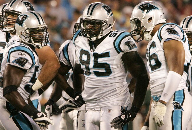 CHARLOTTE, NC - AUGUST 21:  Linebacker Jon Beason  #52, left, of the Carolina Panthers signals to his team during their preseason game against the New York Jets at Bank of America Stadium on August 21, 2010 in Charlotte, North Carolina. (Photo by Mary Ann Chastain/Getty Images)
