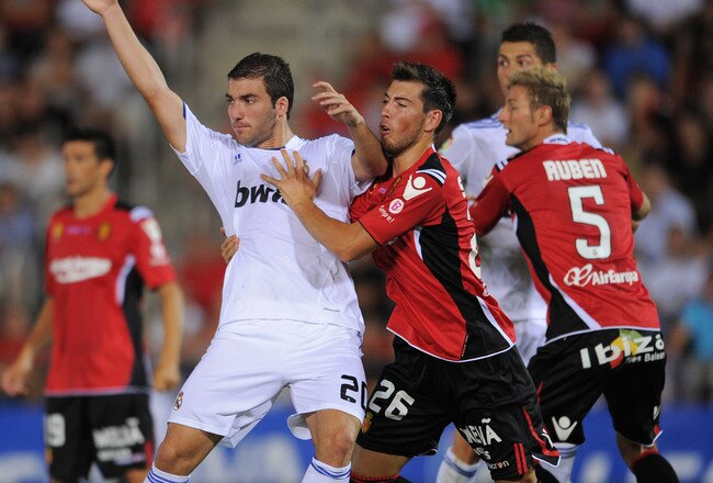 PALMA DE MALLORCA, SPAIN - AUGUST 29:  Gonzalo Higuain (L) of Real Madrid scuffles with Yeray Gomez of Mallorca during the La Liga match between Mallorca and Real Madrid at the ONO Estadio on August 29, 2010 in Palma de Mallorca, Spain. The match ended in a 0-0 draw.  (Photo by Jasper Juinen/Getty Images)