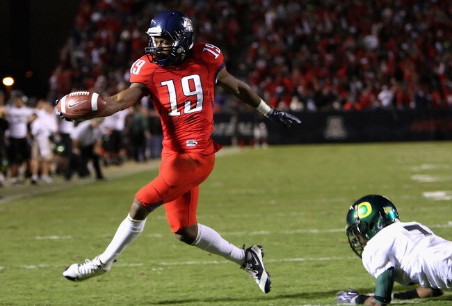 TUCSON, AZ - NOVEMBER 21:  Wide receiver William Wright #19 of the Arizona Wildcats scores a third quarter touchdown past Chad Peppars #7 of the Oregon Ducks during the college football game at Arizona Stadium on November 21, 2009 in Tucson, Arizona.  (Photo by Christian Petersen/Getty Images)