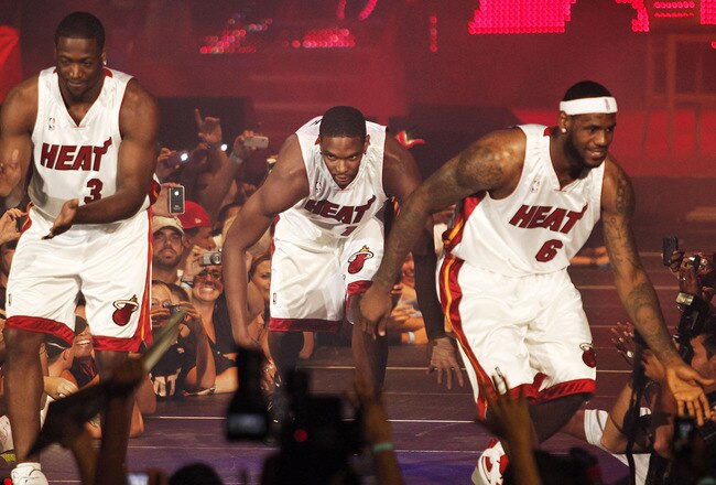 MIAMI - JULY 09:  Fans cheer as (L-R) Dwyane Wade #3, Chris Bosh #1 and LeBron James #6 of the Miami Heat are introduced during a welcome party at American Airlines Arena on July 9, 2010 in Miami, Florida.  (Photo by Marc Serota/Getty Images)