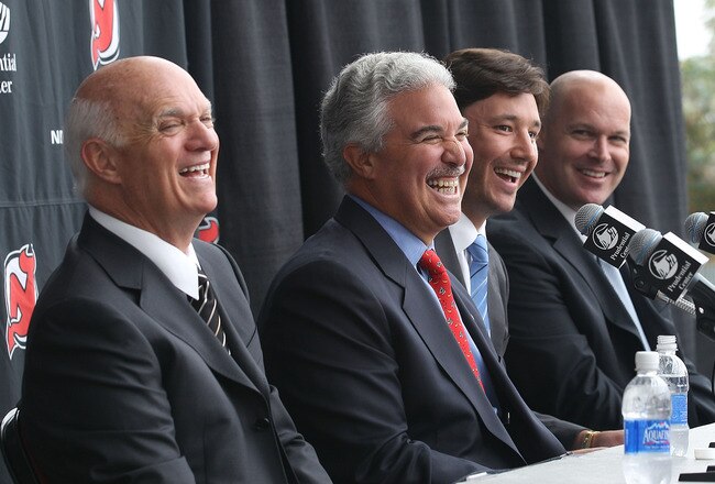 NEWARK, NJ - JULY 20:  (L-R) General Manager Lou Lamoriello, owner Jeff Vanderbeek, Ilya Kovalchuk, and head coach John Maclean of the New Jersey Devils speak with the media during a press conference announcing his contract renewal at the Prudential Center on July 20, 2010 in Newark, New Jersey.  (Photo by Bruce Bennett/Getty Images)