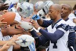 OXNARD, CA - AUGUST 14:  Wide receivers Patrick Crayton (L) #84 and Sam Hurd #17 sign autographs for fans during Dallas Cowboys Training Camp at the Marriott Residence Inn Oxnard River Ridge on August 14, 2010 in Oxnard, California.  (Photo by Jeff Gross/Getty Images)