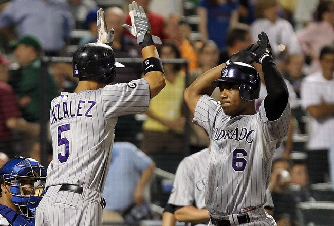 NEW YORK - AUGUST 11:  Melvin Mora #6 of the Colorado Rockies celebrates with teammate Carlos Gonzalez #5 after he hit a grand slam home run in the 8th inning against the New York Mets at Citi Field on August 11, 2010 in the Flushing neighborhood of the Queens borough of New York City.  (Photo by Nick Laham/Getty Images)