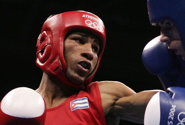 ATHENS - AUGUST 28:  Yuriorkis Gamboa Toledano of Cuba (Red) and Jerome Thomas of France compete during the men's boxing 51 kg final bout on August 28, 2004 during the Athens 2004 Summer Olympic Games at Peristeri Olympic Boxing Hall in Athens, Greece. (Photo by Al Bello/Getty Images)