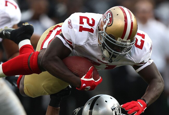 OAKLAND, CA - AUGUST 28:  Frank Gore #21 of the San Francisco 49ers runs against Michael Huff #24 of the Oakland Raiders during an NFL preseason game at Oakland-Alameda County Coliseum on August 28, 2010 in Oakland, California.  (Photo by Jed Jacobsohn/Getty Images)