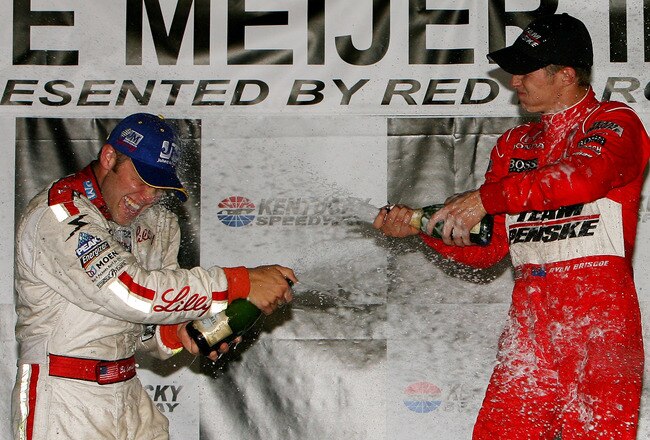 SPARTA, KY - AUGUST 01:  Ryan Briscoe, driver of the #6 Team Penske Dallara Honda celebrates by spraying champagne over second placed Ed Carpenter after winning the IRL IndyCar Series Meijer Indy 300 on August 1, 2009 at the Kentucky Speedway in Sparta, Kentucky.  (Photo by Darrell Ingham/Getty Images)