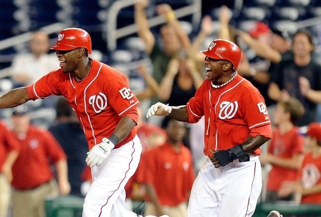 WASHINGTON - AUGUST 26:  Ian Desmond #6 of the Washington Nationals celebrates with Roger Bernadina #2 and Nyjer Morgan #1 after driving in the game winning run in the thirteenth inning against the St. Louis Cardinals at Nationals Park on August 26, 2010 in Washington, DC.  The Nationals won the game 11-10.  (Photo by Greg Fiume/Getty Images)