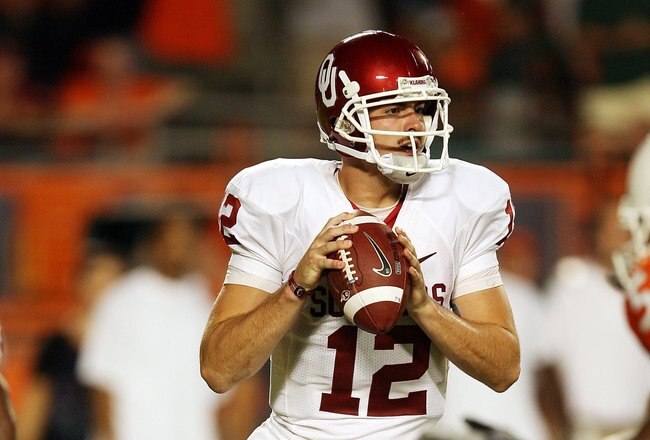 MIAMI GARDENS, FL - OCTOBER 03:  Quarterback Landry Jones #12 of the Oklahoma Sooners drops back to pass against the Miami Hurricanes at Land Shark Stadium on October 3, 2009 in Miami Gardens, Florida. Miami defeated Oklahoma 21-20.  (Photo by Doug Benc/Getty Images)