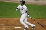 NEW YORK - AUGUST 22:  Marcus Thames #38 of the New York Yankees follows through on a ninth inning RBI single against the Seattle Mariners on August 22, 2010 at Yankee Stadium in the Bronx borough of New York City.The Yankees defeated the Mariners 10-0.  (Photo by Jim McIsaac/Getty Images)