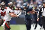 SEATTLE - DECEMBER 20:  T.J. Houshmandzadeh #84 of the Seattle Seahawks straight arms Sabby Piscitelli #21 of the Tampa Bay Buccaneers during their game on December 20, 2009 at Qwest Field in Seattle, Washington. The Buccaneers defeated the Seahawks 24-7. (Photo by Otto Greule Jr/Getty Images)