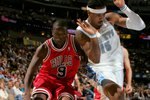 DENVER - NOVEMBER 21:  Luol Deng #9 of the Chicago Bulls drives to the basket against Carmelo Anthony #15 of the Denver Nuggets in NBA action November 21, 2006 at the Pepsi Center in Denver, Colorado. NOTE TO USER: User expressly acknowledges and agrees that, by downloading and or using this photograph, user is consenting to the term and conditions of the Getty Images License Agreement.  (Photo by Doug Pensinger/Getty Images)