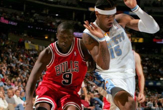 DENVER - NOVEMBER 21:  Luol Deng #9 of the Chicago Bulls drives to the basket against Carmelo Anthony #15 of the Denver Nuggets in NBA action November 21, 2006 at the Pepsi Center in Denver, Colorado. NOTE TO USER: User expressly acknowledges and agrees that, by downloading and or using this photograph, user is consenting to the term and conditions of the Getty Images License Agreement.  (Photo by Doug Pensinger/Getty Images)