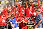 WATKINS GLEN, NY - AUGUST 08:  Juan Pablo Montoya (L), driver of the #42 Target Chevrolet, celebrates with his team after winning the NASCAR Sprint Cup Series Heluva Good! Sour Cream Dips at Watkins Glen International on August 8, 2010 in Watkins Glen, New York.  (Photo by Rusty Jarrett/Getty Images for NASCAR)
