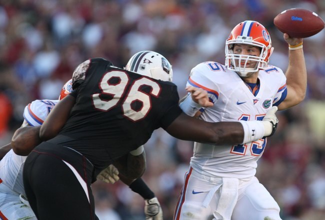 COLUMBIA, SC - NOVEMBER 14:  Tim Tebow #15 of the Florida Gators passes under pressure from Clifton Geathers #96 of the South Carolina Gamecocks at Williams-Brice Stadium on November 14, 2009 in Columbia, South Carolina. (Photo by Streeter Lecka/Getty Images)