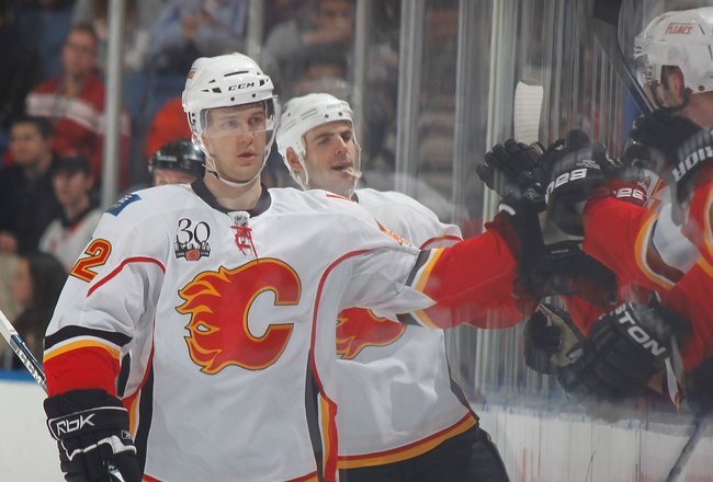 UNIONDALE, NY - MARCH 25:  Forward Brett Sutter #42 of the Calgary Flames gets high fives after a teammates' goal against the New York Islanders during an NHL game at the Nassau Coliseum on March 25, 2010 in Uniondale, New York.  (Photo by Paul Bereswill/Getty Images)