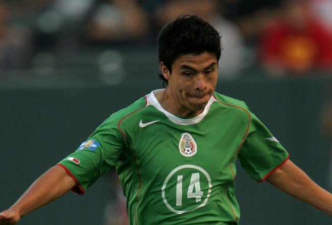 CARSON, CA - JULY 8:   Gonzalo Pineda #14 of Mexico dribbles the ball against South Africa during the CONCACAF Gold Cup game on July 8, 2005 at the Home Depot Center in Carson, California.  South Africa won 2-1.  (Photo by Stephen Dunn/Getty Images)