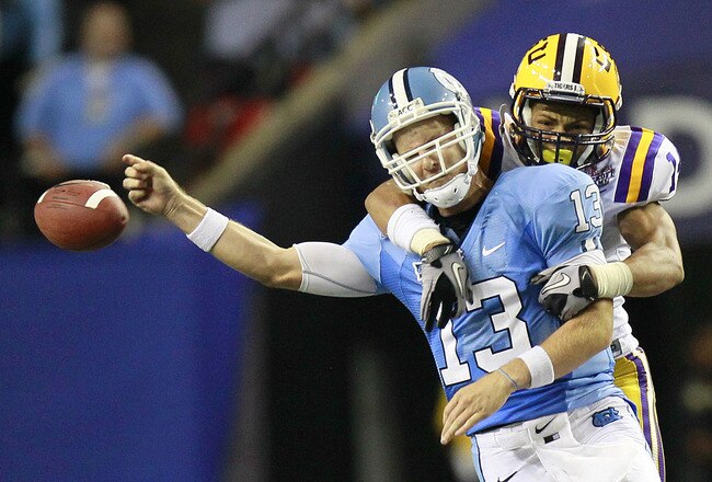 ATLANTA - SEPTEMBER 4: Tyrann Mathieu #14 of the LSU Tigers forces a fumble by quarterback T.J. Yates #13 of the North Carolina Tar Heels at the Georgia Dome September 4, 2010 in Atlanta, Georgia.  (Photo by Kevin C. Cox/Getty Images)