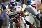 DETROIT - NOVEMBER 18:  Sinorice Moss #83 of the New York Giants fumbles the ball as he is chased by Ernie Sims #50 of the Detroit Lions during the second quarter at Ford Field on November 18, 2007 in Detroit, Michigan.  (Photo by Harry How/Getty Images)