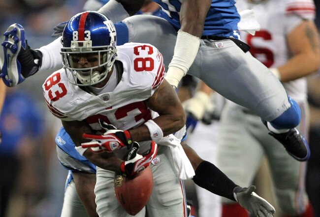 DETROIT - NOVEMBER 18:  Sinorice Moss #83 of the New York Giants fumbles the ball as he is chased by Ernie Sims #50 of the Detroit Lions during the second quarter at Ford Field on November 18, 2007 in Detroit, Michigan.  (Photo by Harry How/Getty Images)