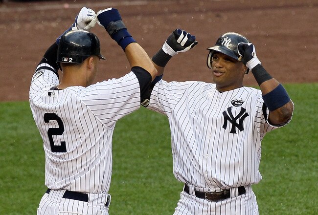 NEW YORK - AUGUST 22:  Robinson Cano #24 (2nd L) of the New York Yankees celebrates his fifth inning grand slam home run against the Seattle Mariners with teammate Derek Jeter #2 on August 22, 2010 at Yankee Stadium in the Bronx borough of New York City.  (Photo by Jim McIsaac/Getty Images)