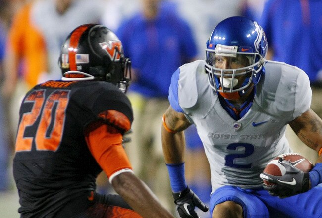 LANDOVER, MD - SEPTEMBER 06:  Wide receiver #2 Austin Pettis of the Boise State Broncos tries to avoid cornerback #21 Rashad Carmichael of the Virginia Tech Hokies at FedExField on September 6, 2010 in Landover, Maryland.  (Photo by Geoff Burke/Getty Images)