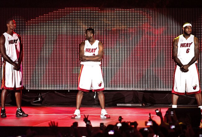 MIAMI - JULY 09:  Fans cheer as (L-R) Chris Bosh #1, Dwyane Wade #3, and LeBron James #6 of the Miami Heat are introduced during a welcome party at American Airlines Arena on July 9, 2010 in Miami, Florida.  (Photo by Marc Serota/Getty Images)