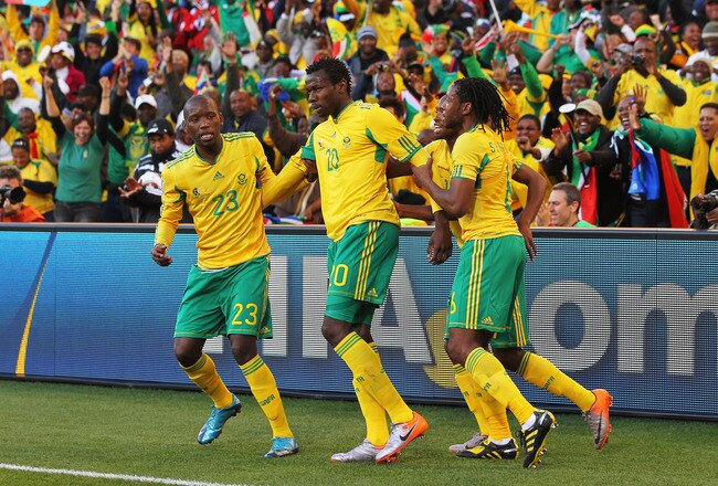 BLOEMFONTEIN, SOUTH AFRICA - JUNE 22:  Bongani Khumalo (#20) of South Africa celebrates scoring the opening goal with team mates during the 2010 FIFA World Cup South Africa Group A match between France and South Africa at the Free State Stadium on June 22, 2010 in Mangaung/Bloemfontein, South Africa.  (Photo by Clive Rose/Getty Images)
