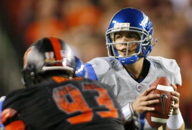 LANDOVER, MD - SEPTEMBER 06: Quarterback #11 Kellen Moore of the Boise State Broncos looks to pass the ball as defensive end #93 Kwamaine Battle of the Virginia Tech Hokies is blocked at FedExField on September 6, 2010 in Landover, Maryland.  (Photo by Geoff Burke/Getty Images)