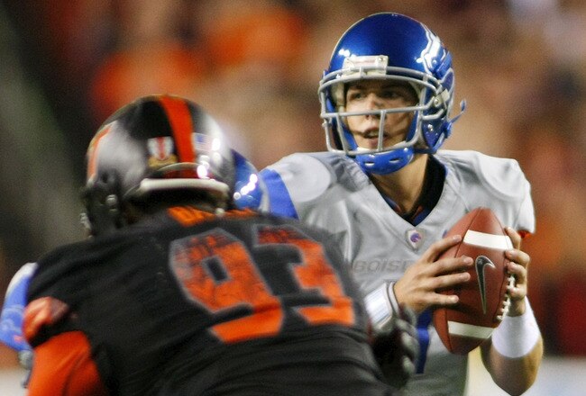 LANDOVER, MD - SEPTEMBER 06: Quarterback #11 Kellen Moore of the Boise State Broncos looks to pass the ball as defensive end #93 Kwamaine Battle of the Virginia Tech Hokies is blocked at FedExField on September 6, 2010 in Landover, Maryland.  (Photo by Geoff Burke/Getty Images)