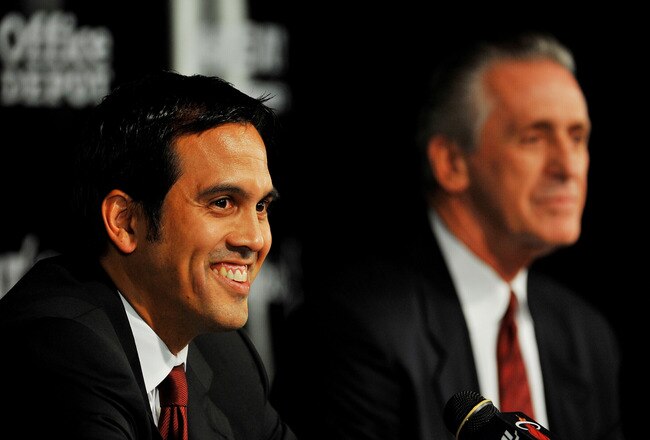 MIAMI - JULY 09:  Head coach Erik Spoelstra (L) and President Pat Riley (R) of the Miami Heat talk during a press conference after a welcome party for new teammates LeBron James, Dwyane Wade, and Chris Bosh at American Airlines Arena on July 9, 2010 in Miami, Florida.  (Photo by Doug Benc/Getty Images)