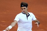 MADRID, SPAIN - MAY 16:  Roger Federer of Switzerland runs to play a forehand against Rafael Nadal of Spain in the mens final match during the Mutua Madrilena Madrid Open tennis tournament at the Caja Magica on May 16, 2010 in Madrid, Spain.  (Photo by Clive Brunskill/Getty Images)