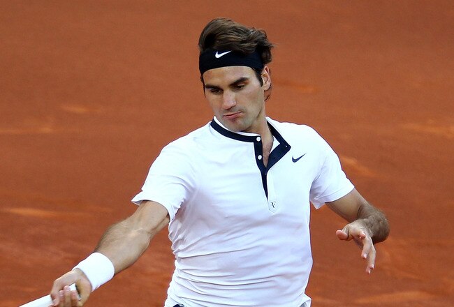MADRID, SPAIN - MAY 16:  Roger Federer of Switzerland runs to play a forehand against Rafael Nadal of Spain in the mens final match during the Mutua Madrilena Madrid Open tennis tournament at the Caja Magica on May 16, 2010 in Madrid, Spain.  (Photo by Clive Brunskill/Getty Images)