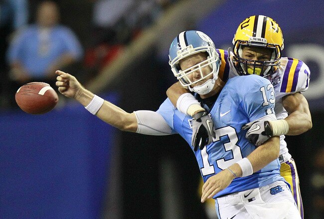 ATLANTA - SEPTEMBER 4: Tyrann Mathieu #14 of the LSU Tigers forces a fumble by quarterback T.J. Yates #13 of the North Carolina Tar Heels at the Georgia Dome September 4, 2010 in Atlanta, Georgia.  (Photo by Kevin C. Cox/Getty Images)