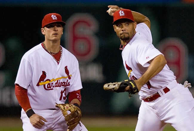 ST. LOUIS - SEPTEMBER 3: Pedro Feliz #77 of the St. Louis Cardinals throws to first base as teammate Brendan Ryan #13 backs him up against the Cincinnati Reds at Busch Stadium on September 3, 2010 in St. Louis, Missouri.  (Photo by Dilip Vishwanat/Getty Images)