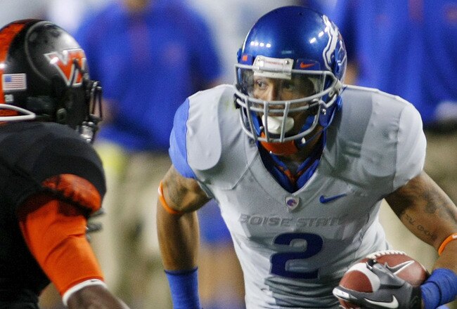 LANDOVER, MD - SEPTEMBER 06:  Wide receiver #2 Austin Pettis of the Boise State Broncos tries to avoid cornerback #21 Rashad Carmichael of the Virginia Tech Hokies at FedExField on September 6, 2010 in Landover, Maryland.  (Photo by Geoff Burke/Getty Images)