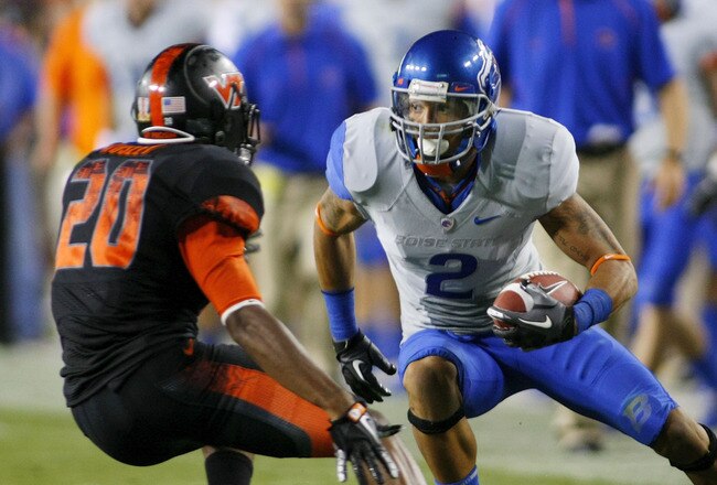 LANDOVER, MD - SEPTEMBER 06:  Wide receiver #2 Austin Pettis of the Boise State Broncos tries to avoid cornerback #21 Rashad Carmichael of the Virginia Tech Hokies at FedExField on September 6, 2010 in Landover, Maryland.  (Photo by Geoff Burke/Getty Images)