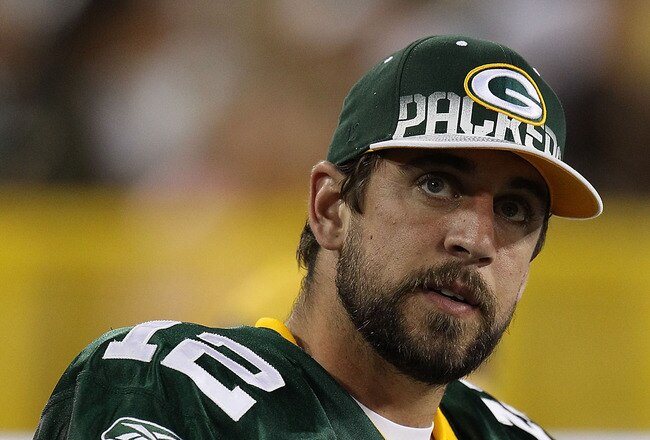 GREEN BAY, WI - AUGUST 26: Aaron Rodgers #12 of the Green Bay Packers watches as his teammates take on the Indianapolis Colts during a preseason game at Lambeau Field on August 26, 2010 in Green Bay, Wisconsin. The Packers defeated the Colts 59-24. (Photo by Jonathan Daniel/Getty Images)