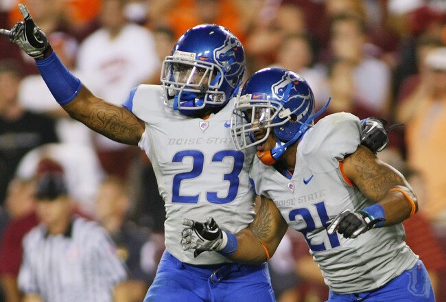 LANDOVER, MD - SEPTEMBER 06:  Safety #23 Jeron Johnson of and cornerback #21 Jamar Taylor of the Boise State Broncos celebrate defeating the Virginia Tech Hokies 33-30 at FedExField on September 6, 2010 in Landover, Maryland.  (Photo by Geoff Burke/Getty Images)