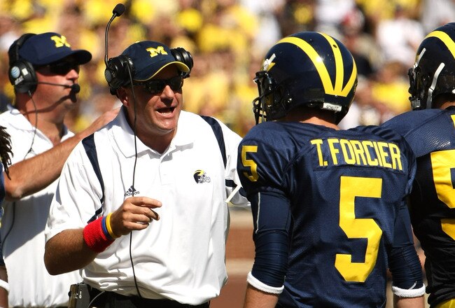 ANN ARBOR, MI - SEPTEMBER 19:  Head coach Rich Rodriguez of the Michigan Wolverines talks with quarterback Tate Forcier #5 during the game with the Eastern Michigan Eagles at Michigan Stadium on September 19, 2009 in Ann Arbor, Michigan.  (Photo by Stephen Dunn/Getty Images)