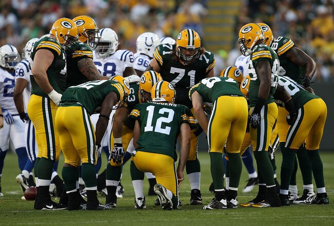 GREEN BAY, WI - AUGUST 26: Aaron Rodgers #12 of the Green Bay Packers calls a play in the huddle against the Indianapolis Colts during a preseason game at Lambeau Field on August 26, 2010 in Green Bay, Wisconsin. The Packers defeated the Colts 59-24. (Photo by Jonathan Daniel/Getty Images)