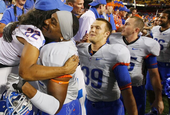 LANDOVER, MD - SEPTEMBER 06:  Linebacker #52 Derrell Acrey of the Boise State Broncos hugs a fan after the Broncos defeated the Virginia Tech Hokies 33-30 at FedExField on September 6, 2010 in Landover, Maryland.  (Photo by Geoff Burke/Getty Images)