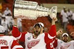 PITTSBURGH - JUNE 04:  Kyle Quincey #4 of the Detroit Red Wings celebrates with the Stanley Cup after defeating the Pittsburgh Penguins in game six of the 2008 NHL Stanley Cup Finals at Mellon Arena on June 4, 2008 in Pittsburgh. Pennsylvania. The Red Wings defeated the Penguins 3-2 to win the Stanley Cup Finals 4 games to 2.  (Photo by Dave Sandford/Getty Images)
