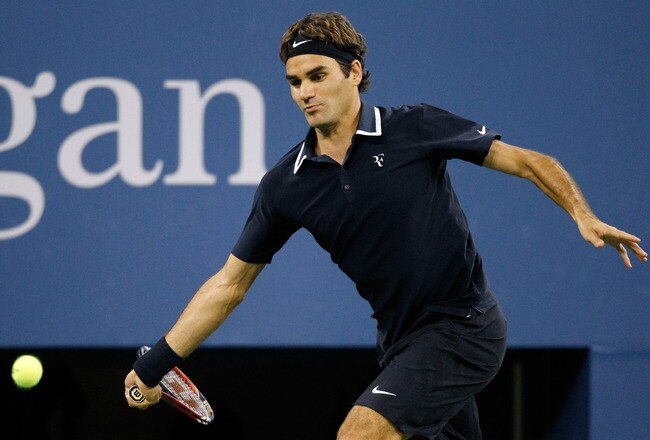 NEW YORK - SEPTEMBER 08:  Roger Federer of Switzerland returns a shot against Robin Soderling of Sweden during his men's singles quarterfinal match on day ten of the 2010 U.S. Open at the USTA Billie Jean King National Tennis Center on September 8, 2010 in the Flushing neighborhood of the Queens borough of New York City.  (Photo by Matthew Stockman/Getty Images)