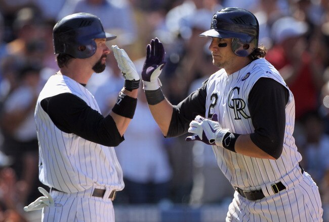 DENVER - SEPTEMBER 06:  Shortstop Troy Tulowitski #2 of the Colorado Rockies is welcomed home by Todd Helton #17 after his solo home run off of relief pitcher Bill Bray of the Cincinnati Reds in the fifth inning at Coors Field on September 6, 2010 in Denver, Colorado. The Rockies defeated the Reds 10-5.  (Photo by Doug Pensinger/Getty Images)